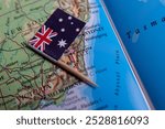 A close-up of the flag of Australia on the map. The capital of Canberra. Close-up of the world map. Australia