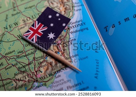 A close-up of the flag of Australia on the map. The capital of Canberra. Close-up of the world map. Australia