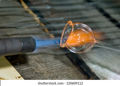 Closeup of a flame and melting glass piece