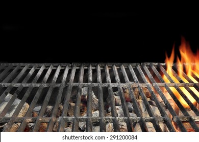 Close-up Of Flaming BBQ Charcoal Grill Isolated On Black Background