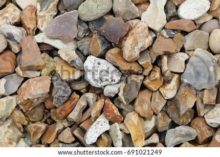 A closeup of flint stone pebbles background