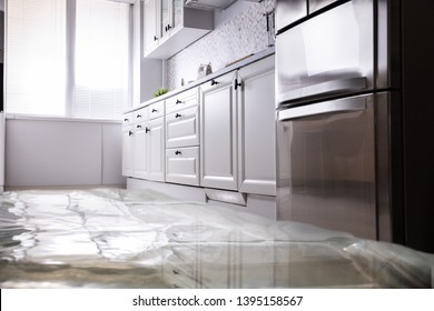 Close-up Of Flooded Floor In Kitchen From Water Leak - Shutterstock ID 1395158567
