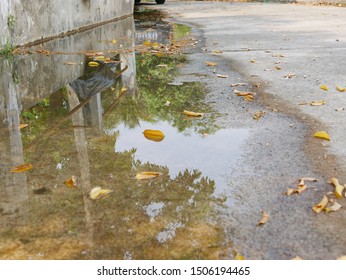Closeup of flooding roadway side as the clogged or ineffective street drainage system failed to release the water from the road