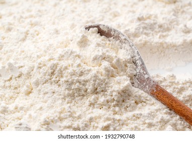 Close-up of flour and scooped wooden spoon