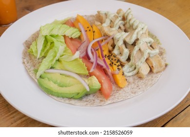 A Closeup Of The Flour Tortilla Bowl, Unwrapped Burrito On The Wooden Table