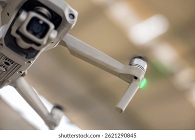 Close-Up of flying drone and its camera. The background is softly blurred. Emphasizing the drone’s high-tech design. Selective focus.
