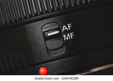 Closeup of the focus window on the camera lens. Close-up of the AF switch on the camera lens.
