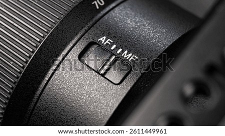 Closeup of the focus window on the camera lens. Close-up of the AF switch on the camera lens.
