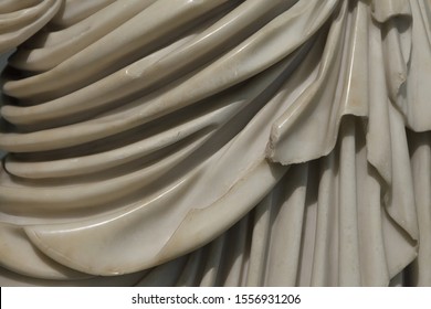 Close-up Folds Of Dress Of Classic Marble Ancient Sculpture. 