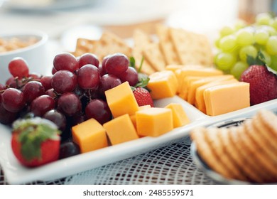 Closeup, food and snack platter with fruit for healthy wellness, vitamin and vegetarian diet on table. Grapes, cheese and crackers on plate with nutrition, hungry eating and meal for brunch or picnic - Powered by Shutterstock