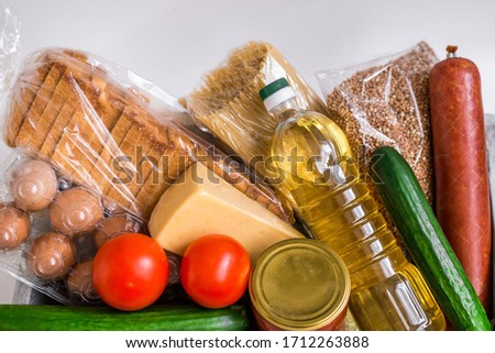 Close-up of food. Vegetables, groceries, cheese and eggs on a white background.
