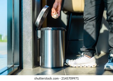 Closeup Foot And Sneaker Of A Woman Placed On The Tread Or Step-on Trash Can In The Room To Drop The Tissue Paper