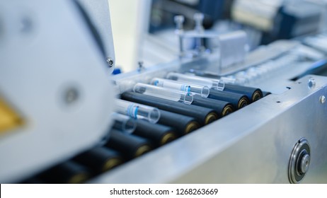 Close-up Footage of the Industrial Manufacturing Medical Test Tubes Moving on the Industrial Converyor. Sterile High Precision Factory Machinery Producing Items for Medical Use. Abstract Concept. - Powered by Shutterstock