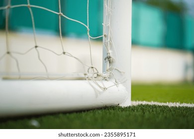 Close-up at football goal post structure which is placed on artificial turf ground pitch. Sport equipment object photo. - Powered by Shutterstock