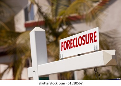 Close-up Foreclosure Real Estate Sign In Front Of House.