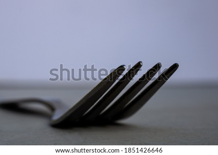 Close-up of fork tines with selective focus. Minimalist macro photography with empty space for text