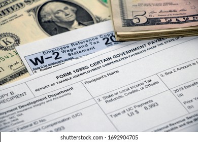 Closeup Of Form 1099G For Unemployment Benefits With W2, Cash