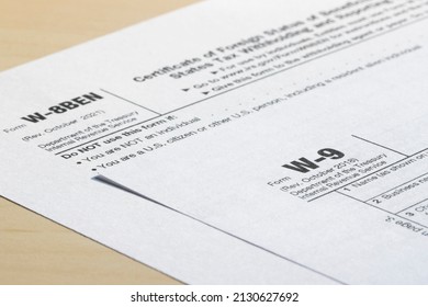 Closeup of Form W-9, Request for Taxpayer Identification Number (TIN) and Certification, and Form W-8 BEN, Certificate of Foreign Status of Beneficial Owner for U.S. Tax Withholding and Reporting. - Shutterstock ID 2130627692