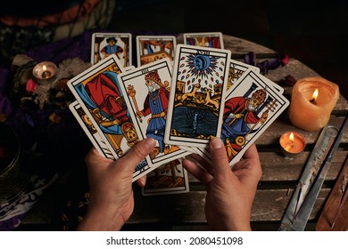 Close-up of a fortune teller reading tarot cards