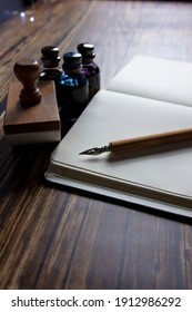 Close-up Of A Fountain Pen On A Notebook And Several Inkwells. Concept Of Writing Poetry. International Poetry Day