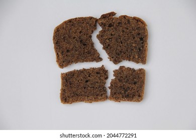 Close-up of four broken pieces of a slice of Lithuanian dark brown rye bread isolated on white background  - Powered by Shutterstock