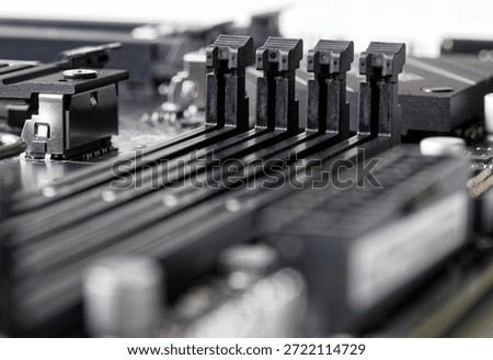 Close-up of four empty DDR5 DIMM slots on a modern computer motherboard. Concept of global semiconductor shortage and expensive electronic components. Photo