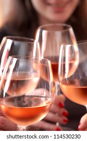 Closeup Of Four Glasses With Wine Being Clinked Together During A Toast At A Celebration