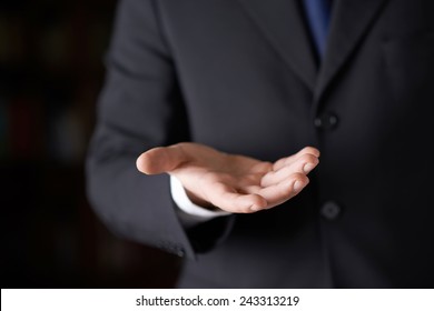 Close-up Fragment Of A Man In A Business Suit Holding A Open Palm In Front Of Him, Shallow Depth Of Field Composition