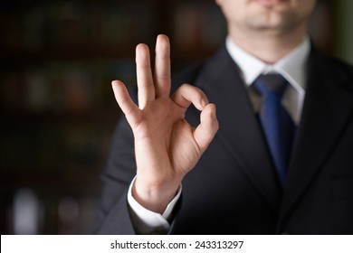 Close-up Fragment Of A Man In A Business Suit Showing An Ok Sign Gesture, Shallow Depth Of Field Composition