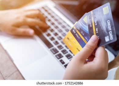 Close-up of freelance people business female Hand holding Credit cards casual working using with laptop computer with coffee cup in coffee shop like the background,Online payment shopping concept - Shutterstock ID 1752142886