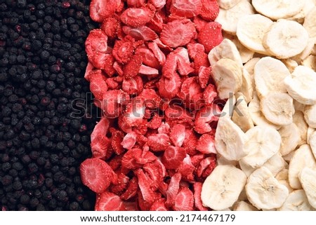 Closeup of freeze dried blueberries, strawberries and bananas as background, top view