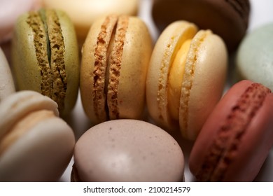 Close-up of French dessert for coffee. Multicolored macarons or macaroons on white background. High quality photo