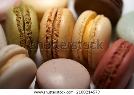 Close-up of French dessert for coffee. Multicolored macarons or macaroons on white background. High quality photo