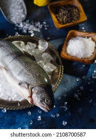 Close-up. Fresh Big Fish In A Bowl With Pieces Of Ice. Salt, Pepper, Spices In Bowls. Cooking Fish Dishes. Restaurant, Cafe, Hotel, Home Cooking, Fish Market.