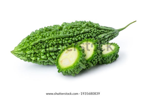 Closeup fresh bitter gourd ( bitter cucumber, Momordica\
Charantia or bitter melon ) with cut slice isolated on white\
background. 