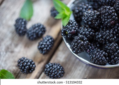 Close-up of fresh blackberries in a bowl on rustic table - Powered by Shutterstock