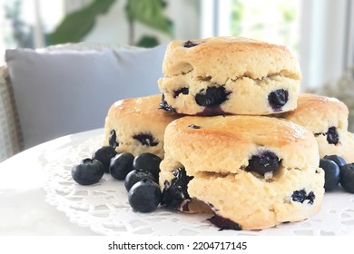 Close-up fresh blueberry scones and some blueberries on the rattan table at home. - Powered by Shutterstock