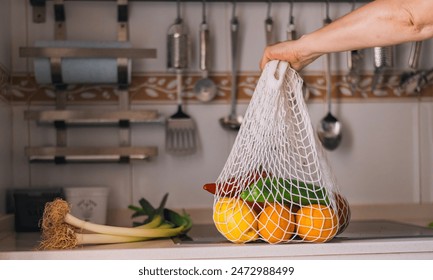 Close-up of Fresh Groceries in Reusable Mesh Bag. Eco-friendly bag filled with fresh produce held by a person. Concept Of Environmental Conservation, Sustainable Lifestyle And Healthy Eating.Green Eco - Powered by Shutterstock