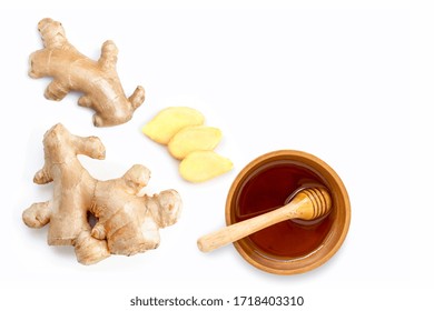 Closeup fresh organic ginger root with slice and pure honey in wooden bowl isolated on white background.Top view. Flat lay. - Powered by Shutterstock