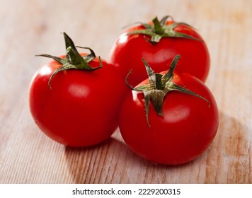 Closeup of fresh ripe tomatoes on wooden surface. Organic vegetables concept - Shutterstock ID 2229200315