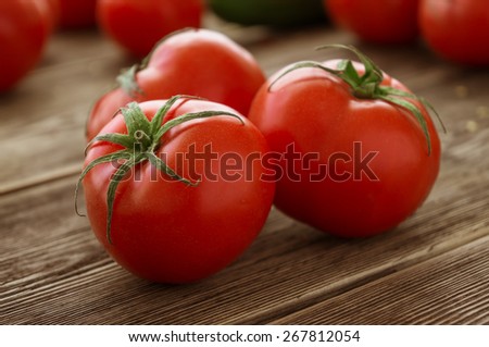 Close-up of fresh, ripe tomatoes on wood background