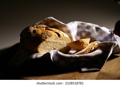 A Closeup Of A Freshly Baked Bread Loaf On A Blue Checkered Cloth