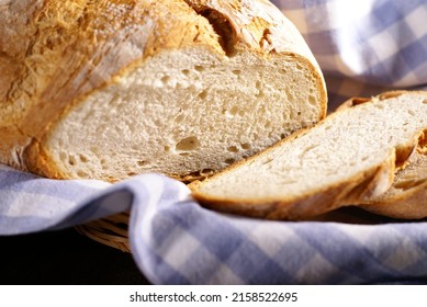 A Closeup Of A Freshly Baked Bread Loaf On A Blue Checkered Cloth