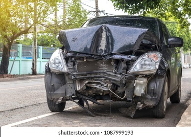 A Close-up Of The Front Black Car, Which Was Demolished By An Accident, Collided With An Electric Pole Until It Was Severely Damaged.