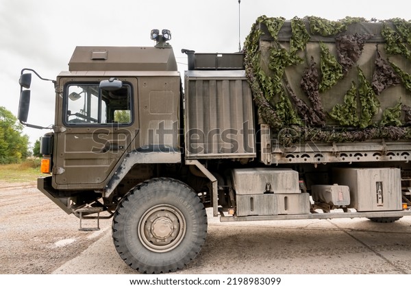 close-up of front\
half and cab of a British army MAN SV HX60 4x4 logistics lorry in\
action on a military\
exercise