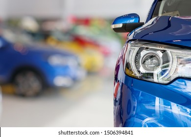 closeup front of new car in showroom background - Shutterstock ID 1506394841