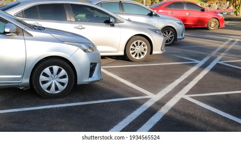 Closeup Of Front Side Of Blue Car With  Other Cars Parking In Outdoor Parking Area In Bright Sunny Day.