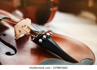 Closeup front side of violin,In selective focus at Fine Tuners,part of the instrument,classic style,vintage and art tone,blurry light around - Shutterstock ID 1378891865