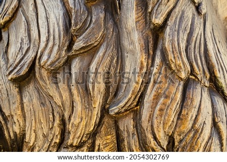 closeup front view of bronze sculpture strands of hair texture