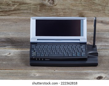 Closeup front view of an old portable minicomputer on rustic wood - Shutterstock ID 222362818